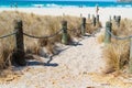 Beach access between rope and bollards across sand path