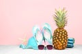 Summer vacation beach accessories against a pastel pink background Royalty Free Stock Photo