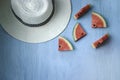 Beach accessories on blue wooden plank  summer holiday on the beach concept  hat and fresh red water melon slicered on wood Royalty Free Stock Photo