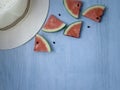 Beach accessories on blue wooden plank  summer holiday on the beach concept  hat and fresh red water melon slicered on wood Royalty Free Stock Photo