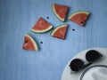 Beach accessories on blue wooden plank  summer holiday on the beach concept  hat and fresh red water melon slicered on wood Royalty Free Stock Photo