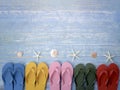 Beach accessories on blue wooden plank  summer holiday on the beach concept  colorful sandals with seashell and starfish Royalty Free Stock Photo