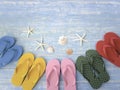 Beach accessories on blue wooden plank  summer holiday on the beach concept  colorful sandals with seashell and starfish Royalty Free Stock Photo