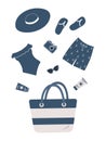 Beach accessories falling into a beach bag. Blue swimsuit, swimming trunks, hat, sunglasses, flip flops, sunscreen, camera