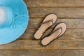 Beach accessories on flip-flops and hat the wood background Royalty Free Stock Photo