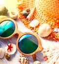 Beach accessories glasses hat cockleshells Royalty Free Stock Photo