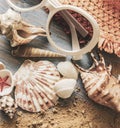 Beach accessories glasses hat cockleshells on wood deck Royalty Free Stock Photo