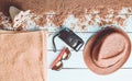 Beach accessories are laid out on a white wooden surface.Hat, camera, sunglasses, towel. The concept of relaxing Royalty Free Stock Photo