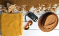 Beach accessories are laid out on a white wooden surface.Hat, camera, sunglasses, towel. The concept of relaxing at sea. Royalty Free Stock Photo