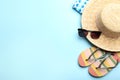 Beach accessories on light blue background, flat lay. Space for text Royalty Free Stock Photo