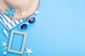 Beach accessories picture frame, sunglasses, starfish, beach hat and sea shell on blue background for summer holiday and vacation