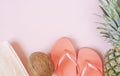 Beach accessories on pink background - pineapple, coconut, towel, flip-flops. Summer is coming concept Royalty Free Stock Photo