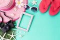 Beach accessories retro film camera Picture Frame, sunglasses, flip flop, starfish beach hat and sea shell on bright pastel green Royalty Free Stock Photo