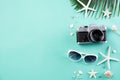 Beach accessories retro film camera, sunglasses, flip flop starfish beach hat and sea shell on green pastel background for summer Royalty Free Stock Photo