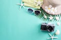 Beach accessories retro film camera, sunglasses, flip flop starfish beach hat and sea shell on green pastel background for summer Royalty Free Stock Photo
