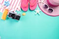 Beach accessories retro film camera, sunglasses, flip flop starfish beach hat and sea shell on green pastel background for summer Royalty Free Stock Photo