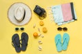 Beach accessories for two, straw beach sunhat,towel, sun glasses on yellow. Summer concept and tropical vacations Royalty Free Stock Photo