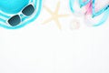 Top border of summer vacation beach accessories on a white wood background with copy space Royalty Free Stock Photo