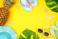 Summer vacation beach accessories frame on a yellow background with copy space Royalty Free Stock Photo