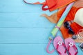 Beach accessory,hat,sunglasses,shoes,umbrella,beach lady hat,earphone,music player and compass on blue wooden background