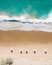 Beach aerial view of umbrellas, waves, blues ocean and relaxing vibes Royalty Free Stock Photo