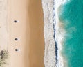 Beach aerial view of umbrellas, waves, blues ocean and relaxing vibes Royalty Free Stock Photo