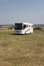 The beach and American style camping car parked on the Sussex Downs, England. Royalty Free Stock Photo