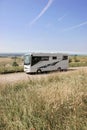 The beach and American style camping car parked on the Sussex Downs, England.