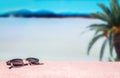 Beach background with free empty blank copy space. Trendy sunglasses on towel in beautiful paradise. Perfect lagoon beach.