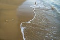 Beach background.Sand and turquoise foamy sea water