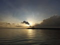 Beach background with the sunrise light over the sea horizon with calm wave water. Sanur Beach morning view.