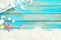 Top viwe of beach sand with white shawl, bracelet made of seashells, starfish, shells and coral on blue wooden background. Royalty Free Stock Photo