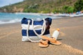 Beach bag, flip flops, sunscreen and sunglasses