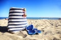 Beach bag sunglasses and hat on the white sandy beach with the blue sky background summer holiday Royalty Free Stock Photo