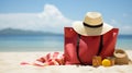 Beach Bag and Supplies for Day at the Beach on Shore with Deserted Beach in Background - Sun Hat, Flip Flops, Towel, Sunscreen Royalty Free Stock Photo