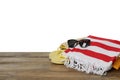 Beach bag with towel, flip flops and sunglasses on wooden surface against white background. Space for text Royalty Free Stock Photo