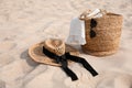 Beach bag, towel, sunglasses and hat on sand, space for text Royalty Free Stock Photo