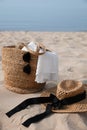 Beach bag, towel, sunglasses and hat on sandy seashore Royalty Free Stock Photo