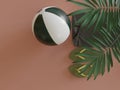 Beach Ball flipflop sandals and towel under tropical leaves in studio viewed from above as minimalism concept