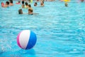 Beach ball floating in a blue swimming pool. Summer background Royalty Free Stock Photo