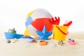 Beach ball and kid toys in sand Royalty Free Stock Photo