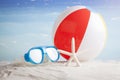 Beach ball and snorkel mask on the beach Royalty Free Stock Photo