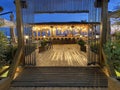 Beach bar counter with chairs in comfortable restaurant at night, view from the entrance Royalty Free Stock Photo