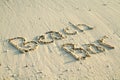 'Beach Bar' written in sand.