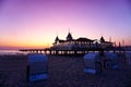 Beach baskets at a beach, a restaurant and a jetty walk at the end of the pier, on the sunset Royalty Free Stock Photo