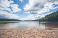 Beach by a beautiful forest lake Royalty Free Stock Photo