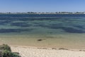 The beach and the beautiful sea of Penguin Island with the coast of Rockingham, Western Australia in the background Royalty Free Stock Photo