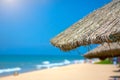 Beach beautiful thatched umbrellas and bright turquoise sea, great recreation and relaxation. tropical paradise. Royalty Free Stock Photo