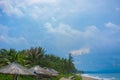 Beach beautiful thatched umbrellas and bright turquoise sea, great recreation and relaxation. tropical paradise. Royalty Free Stock Photo