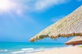 Beach beautiful thatched umbrellas and bright turquoise sea, great recreation and relaxation. tropical paradise. Royalty Free Stock Photo